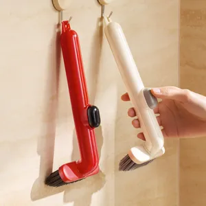Spazzola di pulizia multifunzionale per fughe di bagno e cucina con pratico design rotante.
