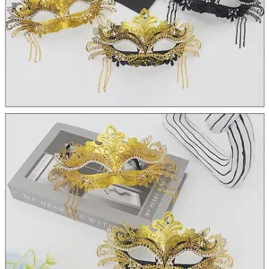Elegant gold and black masquerade mask with rhinestones, lace, and tassels for party.