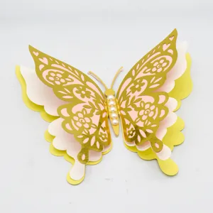 Closeup of 3D 4-layer hollow pearl paper butterfly wall sticker with gold and pink layers.