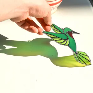 Green hummingbird stained glass suncatcher, translucent acrylic hanging pendant for window decor.