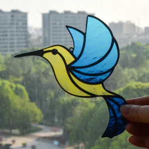 Stained glass hummingbird window hanging sun catcher detail shot showing vibrant blue and yellow.