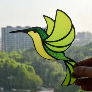 Stained glass hummingbird suncatcher hanging ornament with green and yellow vibrant colors.