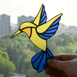 Stained glass style acrylic hummingbird sun catcher detail shot hanging decor item.