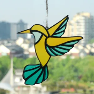 Close-up of a vibrant stained glass hummingbird suncatcher hanging ornament detail view.
