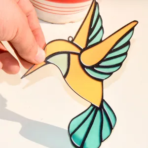 Stained glass hummingbird suncatcher acrylic hanging pendant detail view showing light effect