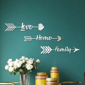 Close-up detail view of 3D acrylic mirror wall stickers featuring arrow and letter designs.