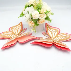 Close-up of 3d hollow butterfly wall stickers with pearl decor, pink and gold design.