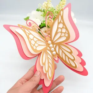 Close-up detail of 3D layered hollow paper butterfly wall sticker with pearls for home decor.