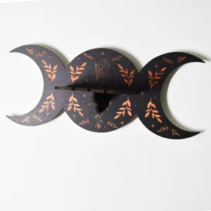 Detail view of the bohemian triple moon wooden wall shelf with carved crystal and leaf motifs.