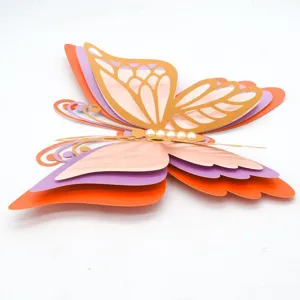 Detail view of 3D layered hollow paper butterfly wall sticker with pearl decor for party.