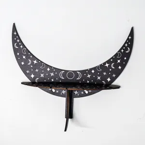 Close-up detail of the wooden moon wall shelf featuring carved stars and moon phase patterns.