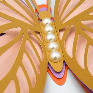 Close-up detail of 3D layered hollow butterfly wall sticker with elegant pearl body texture.