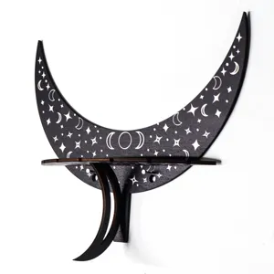 Boho black wooden crescent moon wall shelf with carved celestial star motifs for room decor.