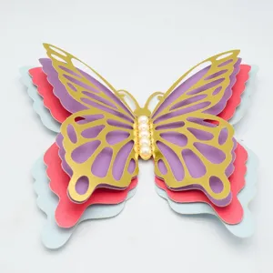Detail shot of the multi-layer hollow 3D butterfly wall sticker with pearl center and gold trim.