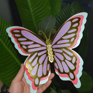 Detail view of the 3D hollow pearl paper butterfly decoration with gold foil and pearls.