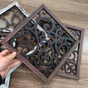 Detailed view of wooden hollow carved wall decor panel featuring intricate scrollwork patterns.
