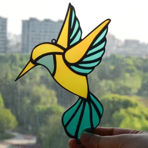 Stained glass hummingbird suncatcher detail view, vibrant yellow blue acrylic hanging decor.