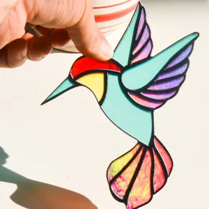 Acrylic hummingbird suncatcher detail, vibrant stained glass style window hanging ornament.