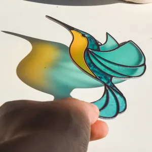 Acrylic hummingbird suncatcher pendant, stained glass style hanging decoration with shadows.
