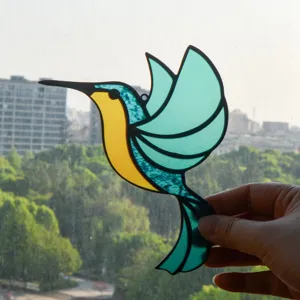 Stained glass hummingbird suncatcher detail, vibrant blue and yellow window hanging decor.