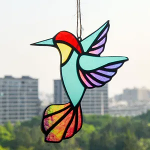 Detailed view of colorful stained glass hummingbird suncatcher hanging ornament with string.