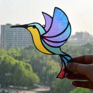 Detailed view of colorful stained glass hummingbird suncatcher, vibrant acrylic hanging decor.