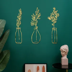 Detail view of 3D acrylic mirror wall stickers with golden vase and plant shapes for home decor.