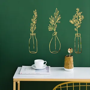 Detail view of 3D gold acrylic mirror vase wall sticker, elegant home decor for living room.