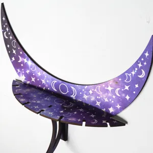 Moon shaped wooden wall shelf detail close-up, purple star pattern, boho home decor accent.