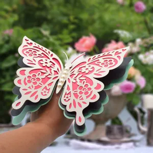 3D 4-layer hollow paper butterfly wall sticker with pearls for wedding and holiday decor.