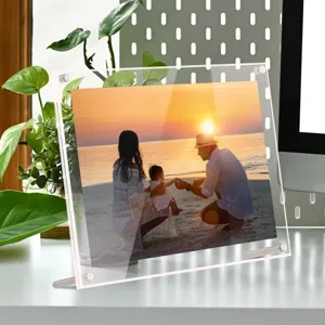Clear acrylic photo frame detail showing double layer design and sturdy metal stand for desk display.