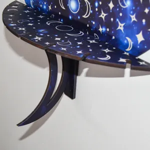 Close-up of wooden wall shelf with celestial moon and stars pattern, boho home decor.