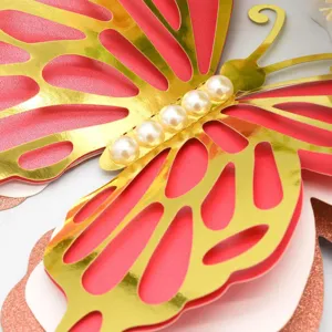 Detail close-up of 3d hollow butterfly wall sticker with gold foil and pearls for decor.