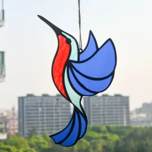 Detailed view of the colorful stained glass hummingbird sun catcher pendant hanging.