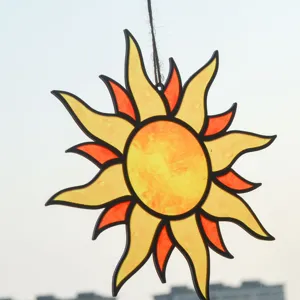 Detailed close-up view of the stained glass suncatcher hanging, vibrant yellow and orange.