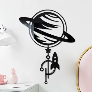 Detail shot of 3D acrylic mirror wall sticker featuring planet and rocket design for home decor.