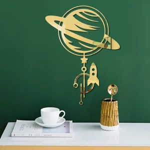 Gold acrylic mirror 3D wall sticker, Saturn and rocket design for home decor detail view.