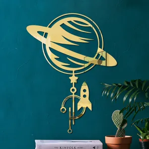 Close-up detail of golden acrylic Saturn and rocket mirror wall sticker, modern home decor accent.