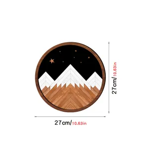 Circular wooden wall art detail showing geometric mountain landscape and starry night design.