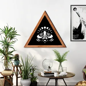 Detailed view of the triangular wooden frame wall art featuring a moth and moon phase design.