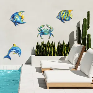 Detail view of vibrant ocean metal wall art, featuring dolphin and fish hanging in pool scene.