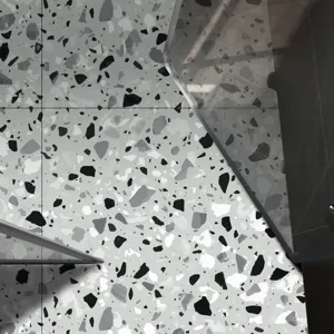 Terrazzo floor sticker self-adhesive tile detail showing black and white modern marble pattern texture.