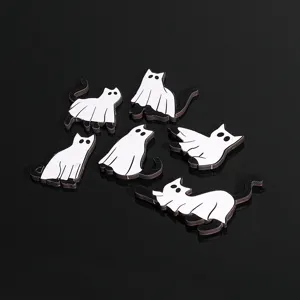 Close-up detail of wooden Halloween ghost cat fridge magnets showing cute spooky designs.