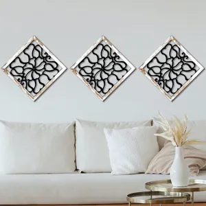 Wooden diamond wall decor set with black hollow floral pattern and distressed white frame.