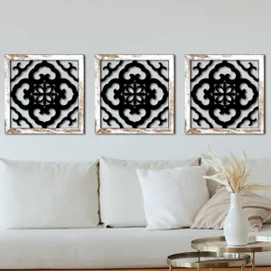 Living room wall art scene with three square distressed wooden frames and black hollow patterns.