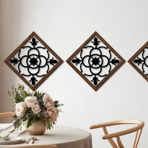Wooden wall art decor panel with black cutout pattern, hanging on white wall detail view.