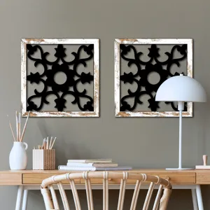 Wooden cutout wall decor set of two with distressed white frames and black floral patterns for living room.