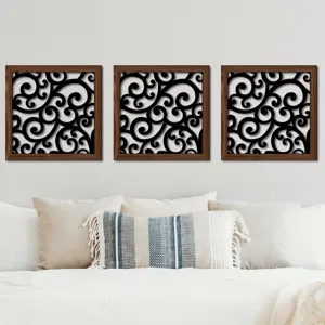 Detailed view of the wooden scroll wall art panel trio hanging gracefully above a cozy bed.