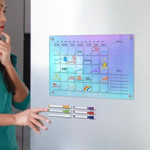 Clear acrylic magnetic calendar board for fridge with dry erase markers and weekly planner notes.