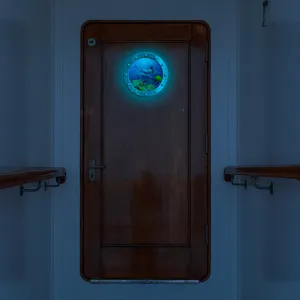 Luminous porthole wall sticker with marine animal design, glowing blue-green for home decor.
